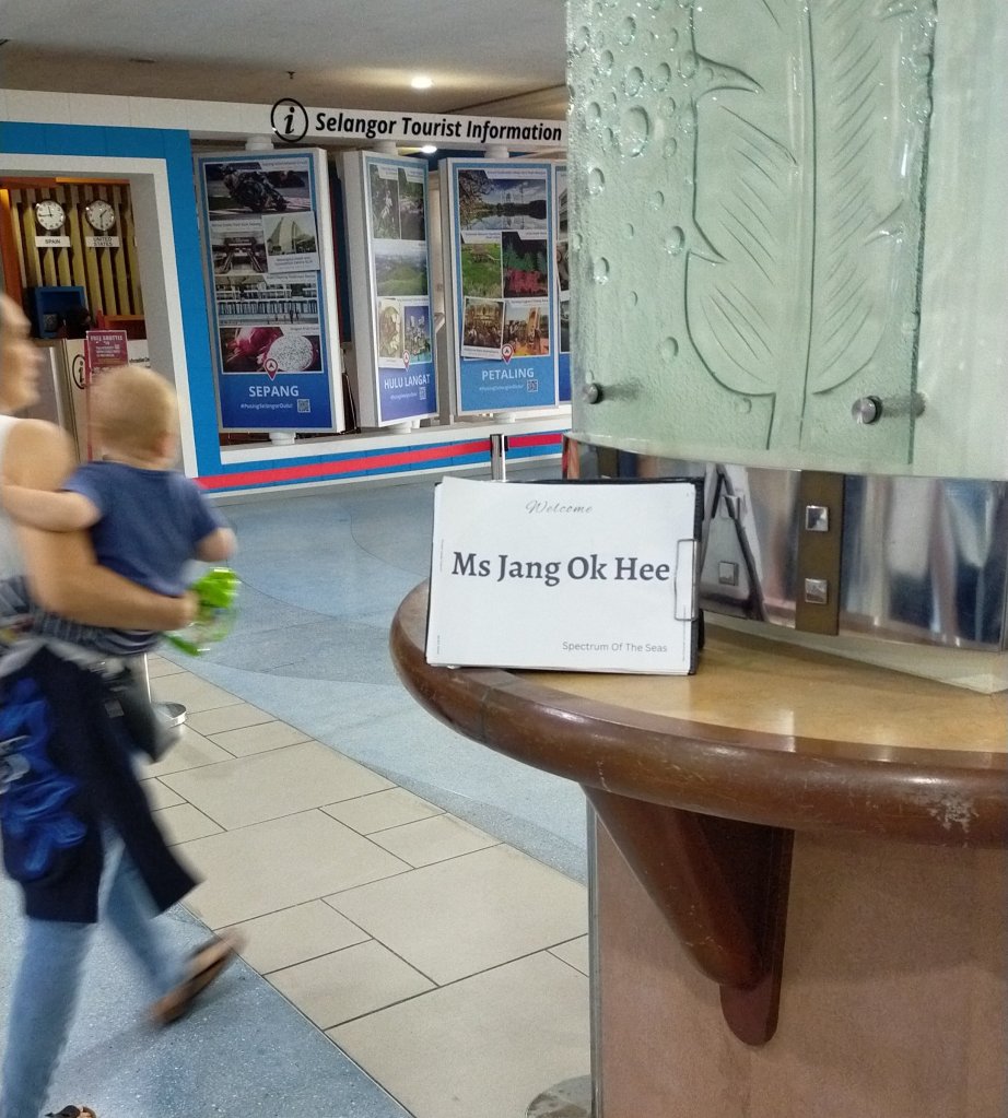waiting at port klang cruise terminal hall with holding up the name card