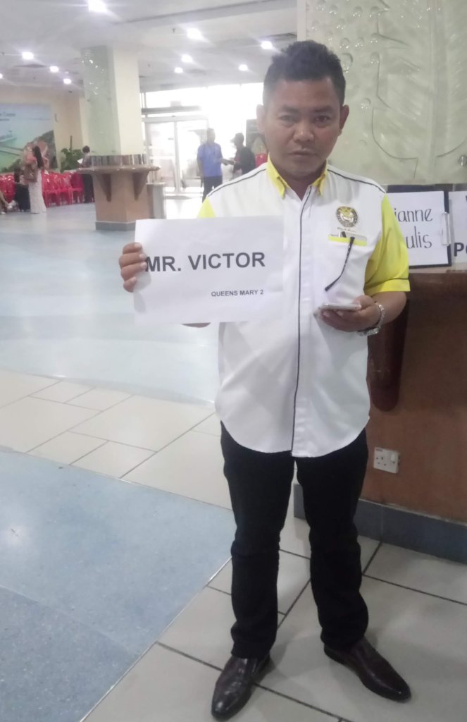 holding up your name card at cruise arrival hall lobby to Kuala Lumpur Malaysia tour